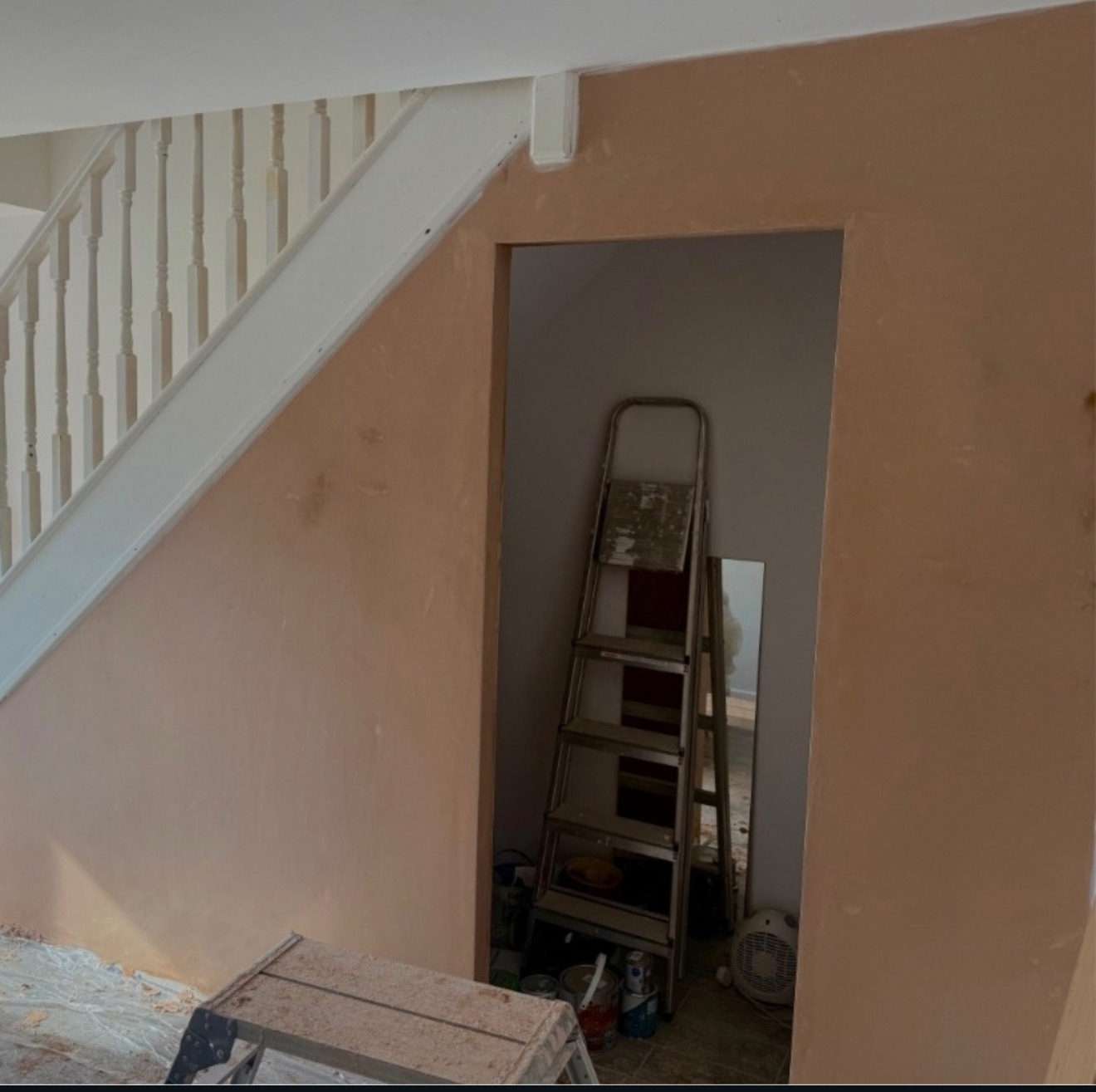 Plastered wall beneath a staircase