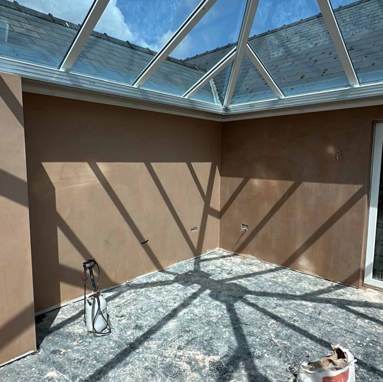 Plastered walls under a glass roof