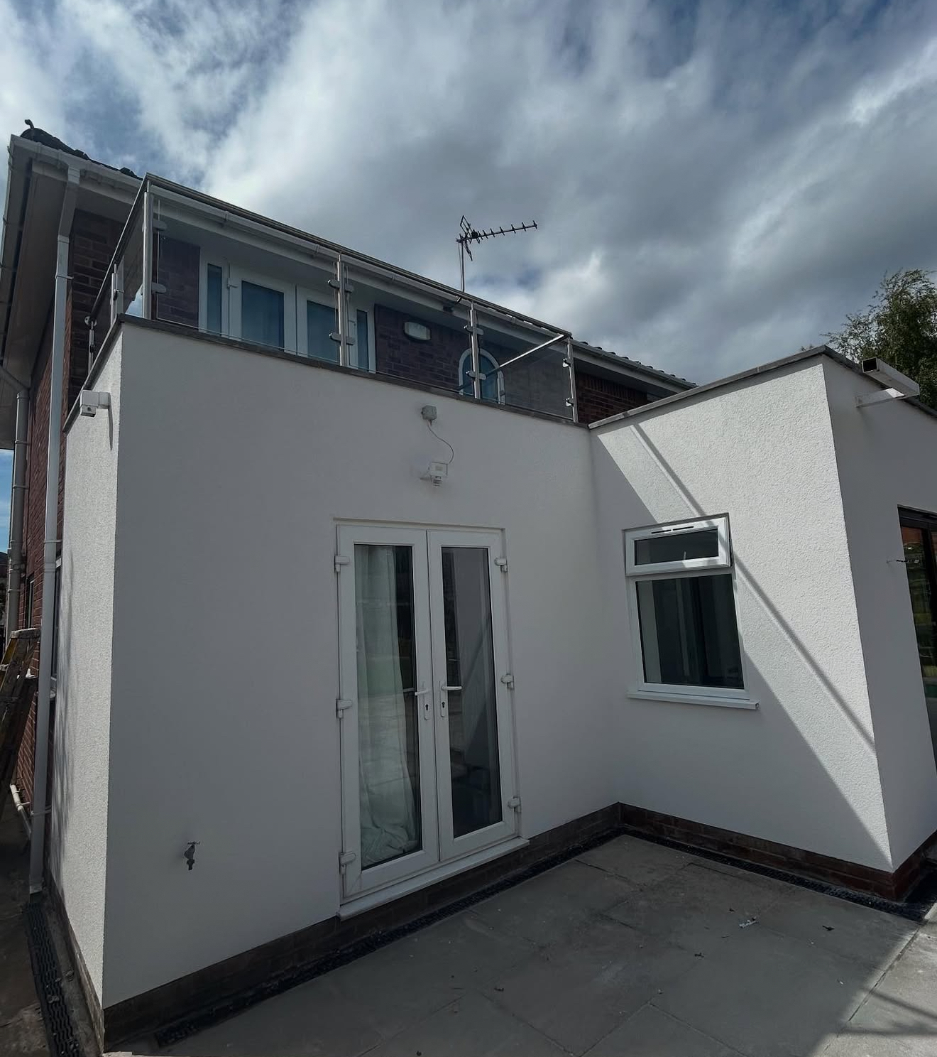 Rendered rear extension with a balcony