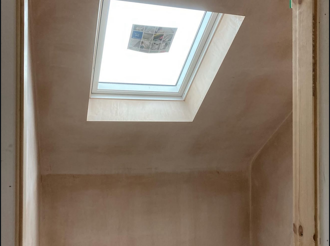 Plastered ceiling around a roof window
