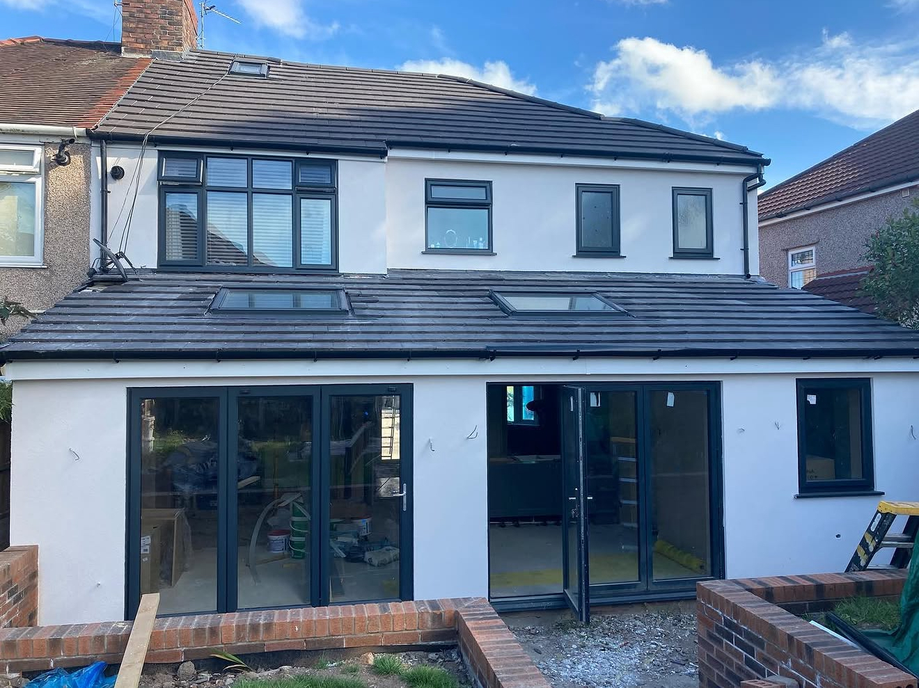 Rendered rear extension with bi-fold doors